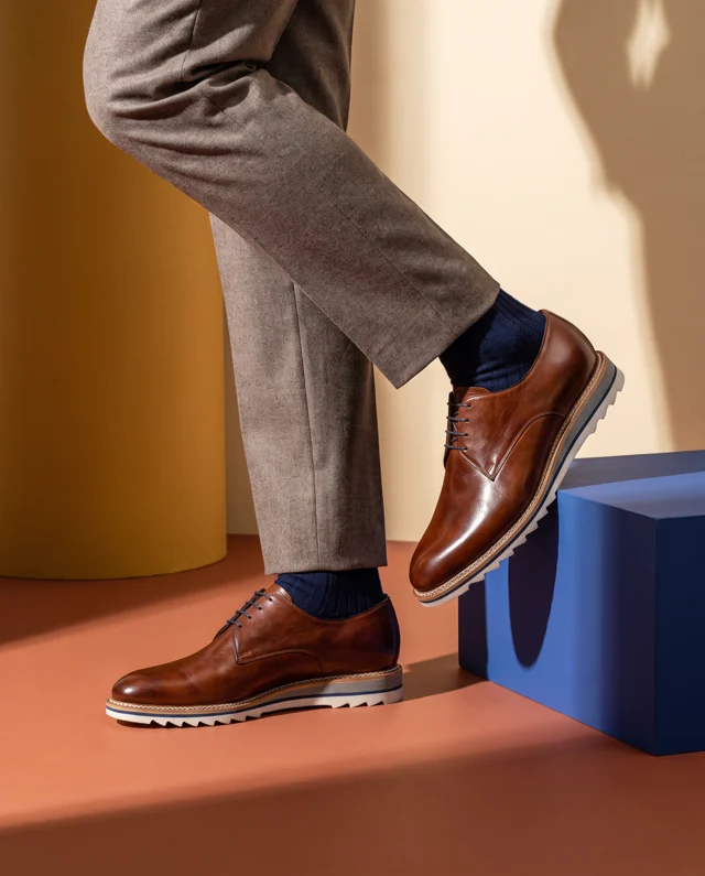 Brown plain-toe lace-up with a pale serrated sole and navy stripe